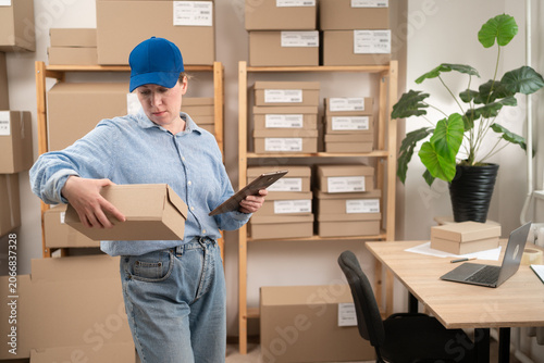 Принти на полотні entrepreneur woman working on Internet store order using application on digital