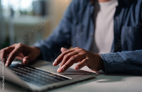 Close-up A Businessman typing laptop computer communicates on internet technology on office desk. Workplace, Businessman professional working on new job project. Business technology concept.