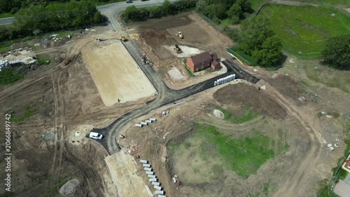 The site at Bellway in Boroughbridge UK shows land being cleared and prepared for new building. Machinery is in operation working on the construction