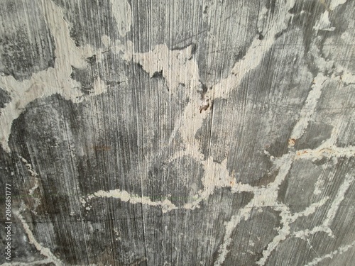 Schilderij op canvas Close-up of aged wall surface with peeling paint, gray patches, white streaks, and textured weathered patterns showing natural decay