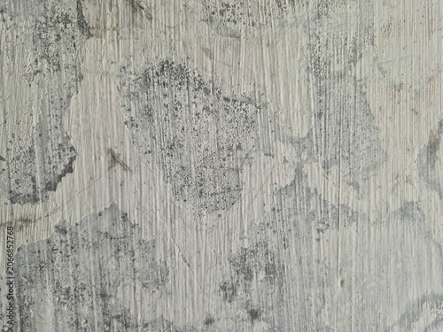 Tableau sur toile Close-up of aged wall surface with peeling paint, gray patches, white streaks, and textured weathered patterns showing natural decay