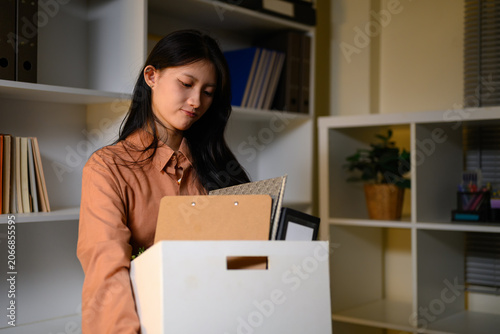 Young Asian Businesswoman Packing Personal Belongings in Box After Resignation Leaving Office Job