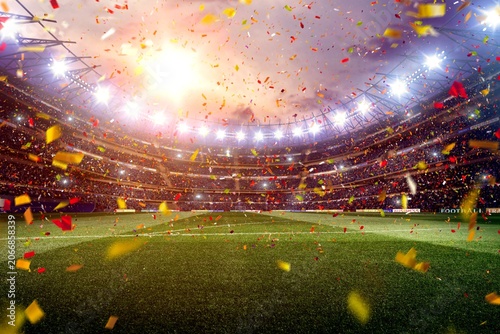 Obraz na plátne Confetti falling over grass soccer field inside brightly lit stadium with confet
