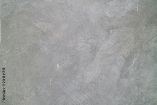 Fotografie Gray concrete wall texture with a rough, uneven, mottled pattern surface in aged, worn style
