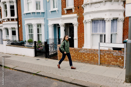 Female tourist walking steadily along London streets