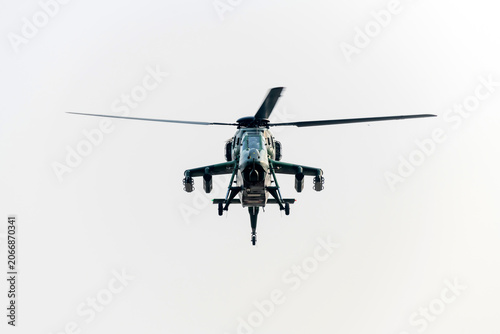 Military helicopter flying on isolated white background