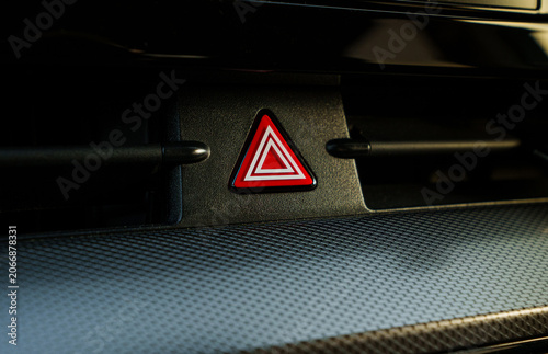 Fotografie Glowing red hazard light button on car dashboard, emergency warning flasher swit