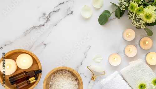 Flat Lay Home Spa Essentials with Oils, Candles and Towels on Marble Background