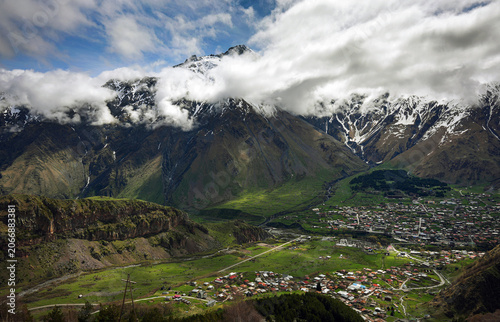 Panoramic View of Kazbegi and Caucasus Mountains Under Dramatic Clouds