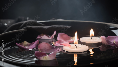 Floating Candles and Flower Petals in Water, Dark Spa Mood with Soft Reflections