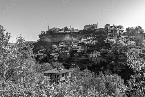Black and white panoramic view of historic Ottoman houses on a steep hillside in Safranbolu.