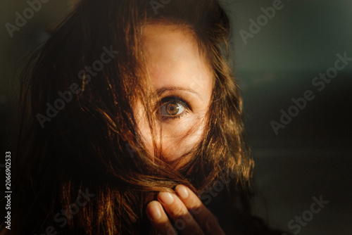 Bild auf Leinwand portrait of a woman covering face with her hair