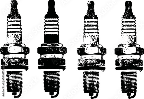 Four vintage spark plugs arranged in a row with detailed worn metal texture