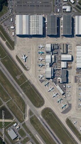 Aerial view of airport terminal with parked airplanes, logistics