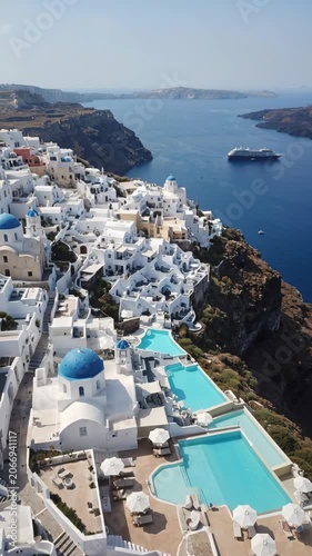 Aerial view of Oia village in Santorini with blue domed churches and