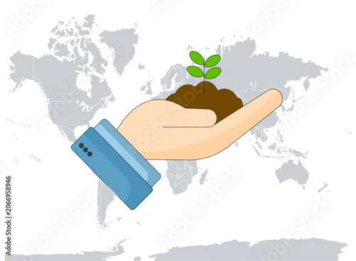 Hand holding a plant sprout and in the background is a world map
