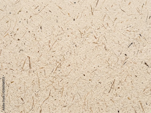 Beige paper texture background with natural fiber and fleck details. Recycled cardboard or craft sheet surface concept