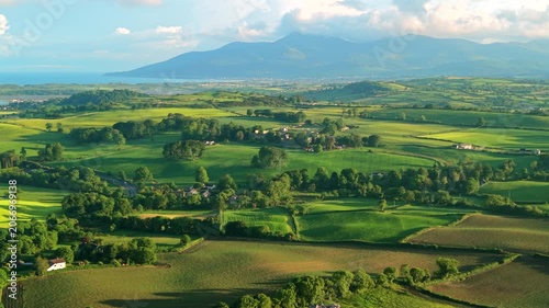 Aerial view of rolling hills and Mourne Mountains during sunset county Down Northern Ireland