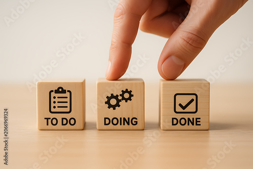 Visualizing project management stages with wooden blocks depicting to do doing and done