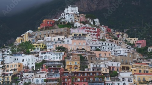 Foto Colorful hillside village with houses and a castle on top