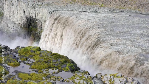 Photos Dam with water flowing over spillway in a river setting