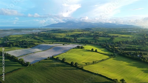 Aerial view of fields and rolling hills with Mourne Mountains during sunset county Down Northern Ireland