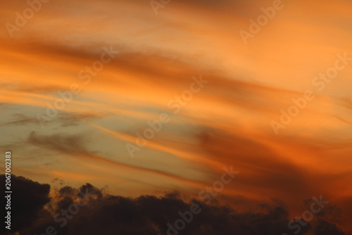 Dramatic sunset sky with clouds. Beautiful orange twilight. Scenic vibrant colors during sundown. Sky during sunset with clouds.