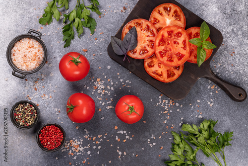 Slicing tomatoes, herbs, and seasonings preparing fresh healthy food