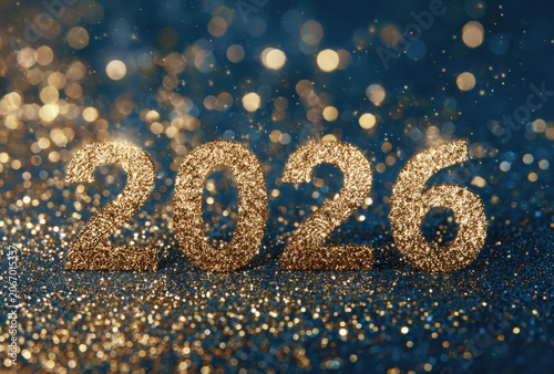 The year 2026 written in large golden glittery numbers against a dark blue background, with sparkling bokeh, lights and golden, particles floating