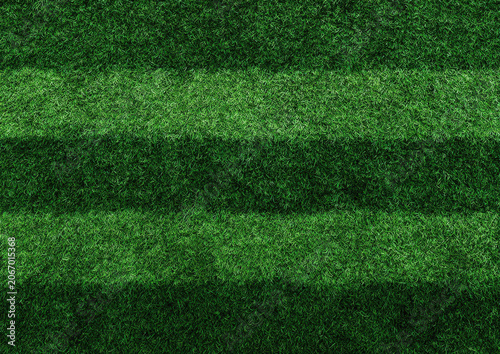 Texture of a green artificial grass surface with alternating light and dark stripes resembling a sports field or stadium pitch
