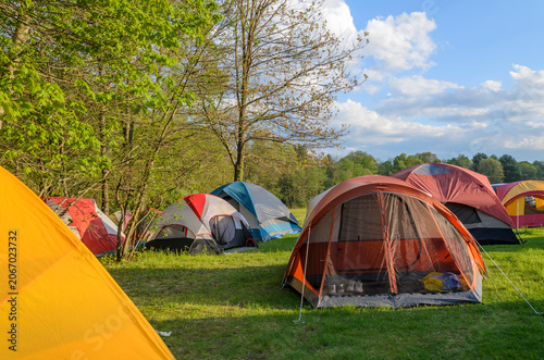 Camping Tents Set Up In Green Forest Campground