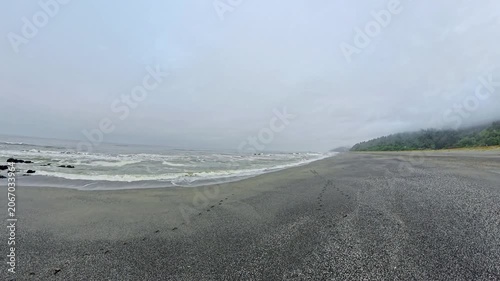 Panning Across Dark Sandy Beach on California Coast in Redwood National Park