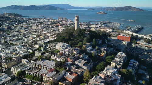 Cinematic drone footage orbiting around Coit Tower on Telegraph Hill in San Francisco. Smooth aerial movement showcasing the iconic Art Deco landmark.