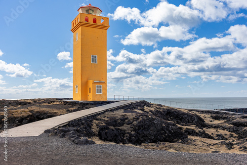 Yellow Svortuloft Lighthouse on Volcanic Coastline of Snaevfellsnes Peninsula in Iceland