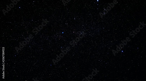 Bild auf Leinwand A rich, dark night sky filled with a multitude of glowing stars and faint, deep-space nebulae