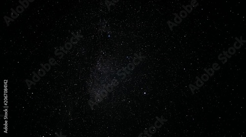 Bild auf Leinwand A rich, dark night sky filled with a multitude of glowing stars and faint, deep-space nebulae