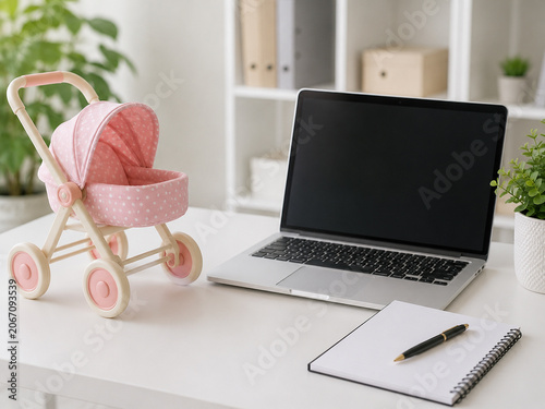 Laptop, Toy Stroller, Notebook, and Pen on a White Desk