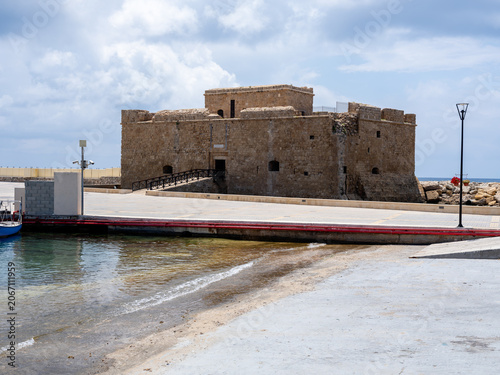 Ancient Stone Castle Fortress in Paphos, Cyprus on the Mediterranean Coastline With Rocky Beach And Blue Sea Waters
