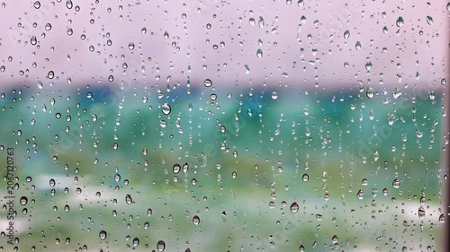 Close-up view of raindrops on window with blurred landscape during rainfall. Miami Beach. USA.