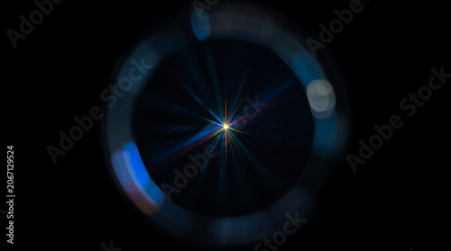 Bright Lens Flare Effect on Black Background with Circular Light Streaks.