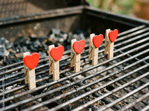 Wooden Clothespins with Red Hearts Clipped to Barbecue Grill