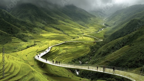 Elevated walkway curves through lush green terraced hillsides under a cloudy sky