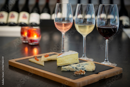 Bild auf Leinwand Delightful Tasting Experience With Green Bottles and Fine Cheeses at the Wine Ba