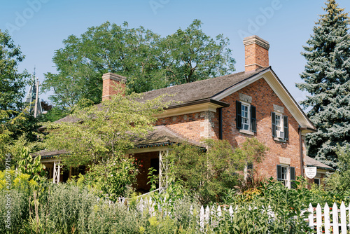 Historic Brick House with Picket Fence in Toronto Garden