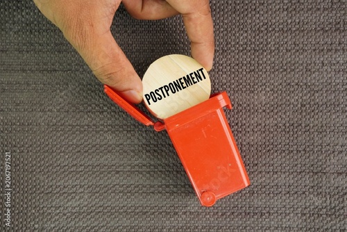Fotografie Trash can throw or remove the word postponement