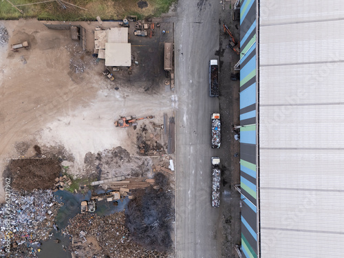 Aerial drone view of an industrial waste yard and factory road
