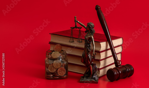 Принти на полотні A jar of US coins, a figure of Themis, a judge's gavel and a stack of books on a