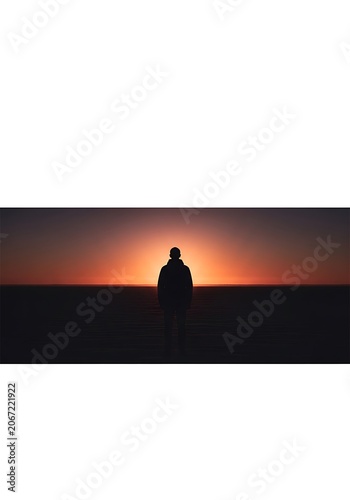 Silhouette of Person Sitting During Sunset on Horizon.