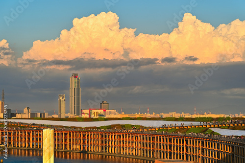 Canvastavla Massive Wooden Ring Structure and Osaka City Skyline Under Dramatic Sunset Cumul