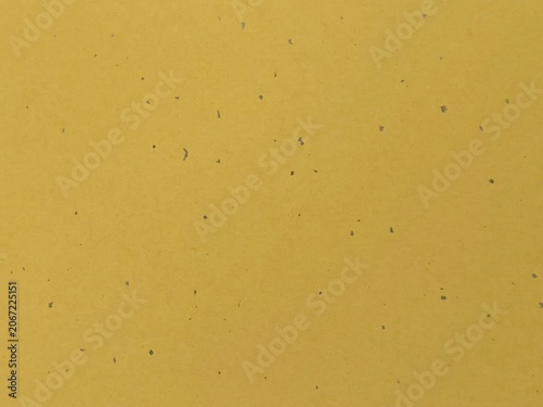 Yellow washi paper texture with dark specks